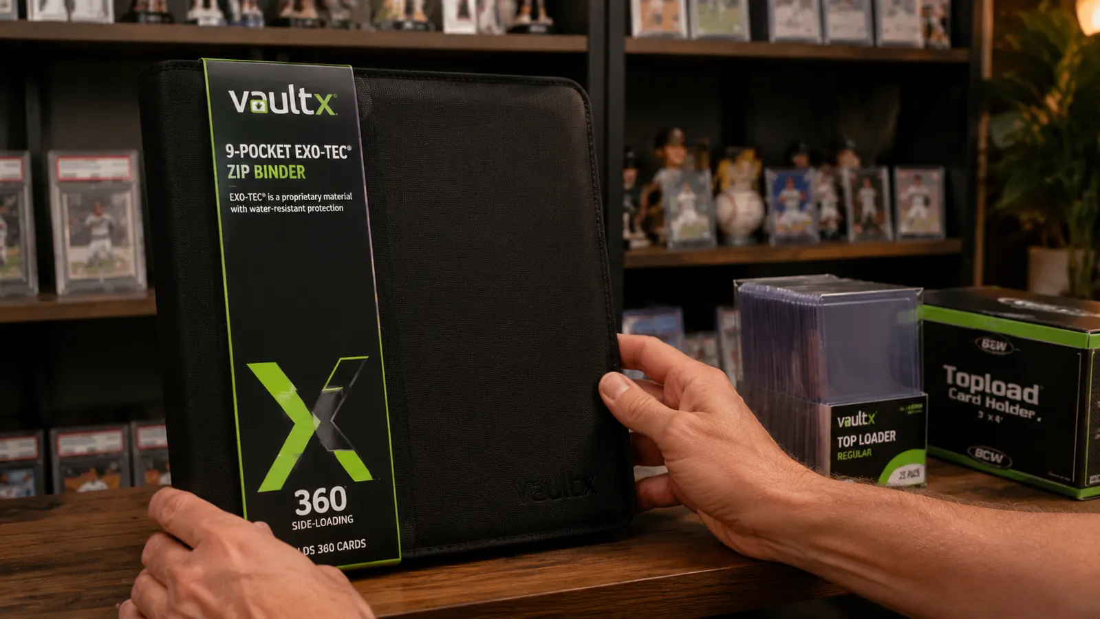 Vault X binder closed with zipper, sitting on a shelf next to other card storage supplies
